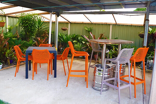 Outdoor entertainment area overlooking the pool at Moore Park Beach Motel, QLD