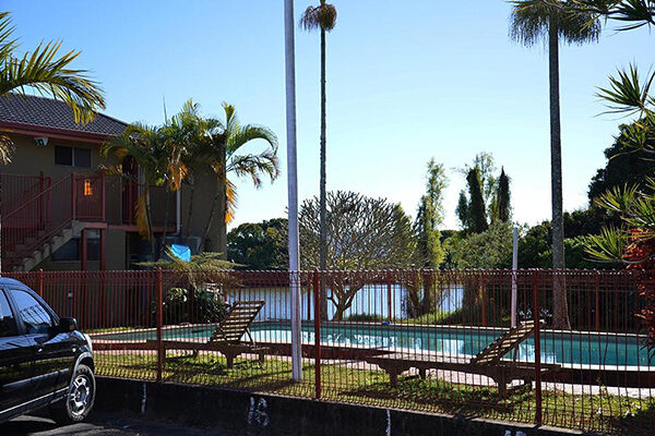 The swimming pool and Tweed River at the Tweed River Motel, Murwillumbah, NSW